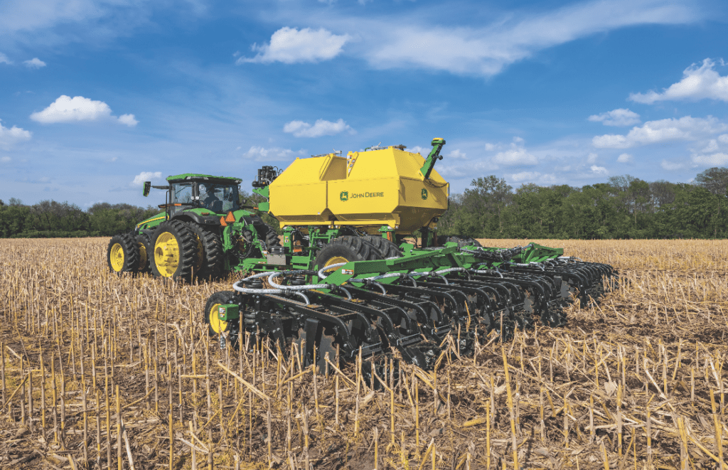 Large agriculture tractor with tillage attachment at work